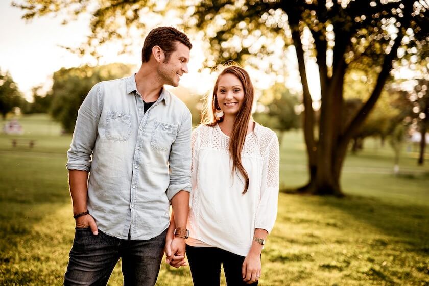 A couple walking hand in hand in a park reflecting on reflecting on their life as a partnership.