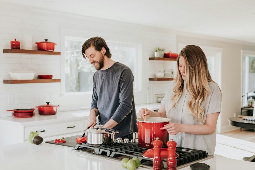 Couple making dinner together feeling connected and aligned together.