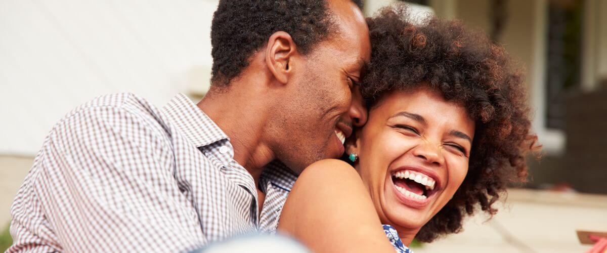 Couple share a joyful moment of connection representing the different layers of married life.