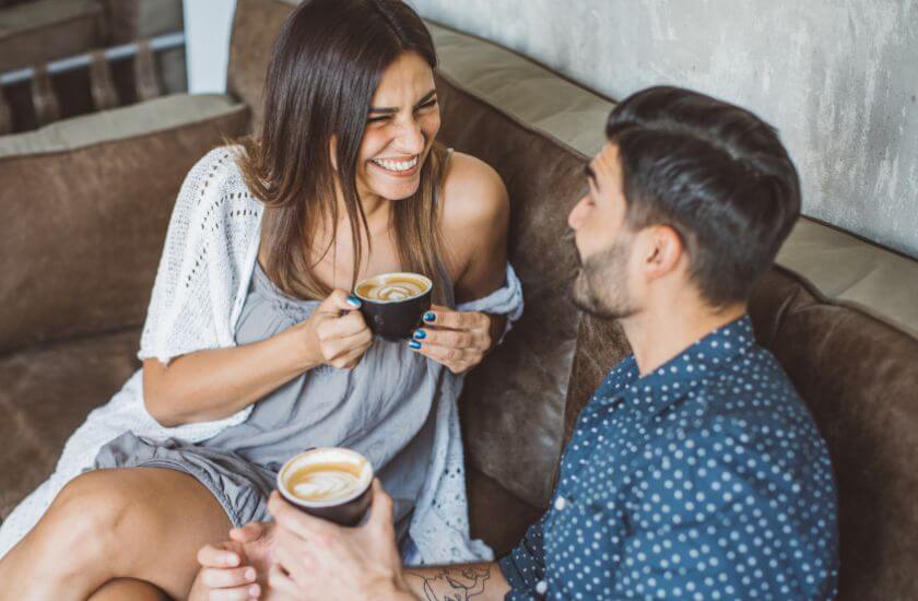 Couple ride bikes along a woodland track appreciating time together