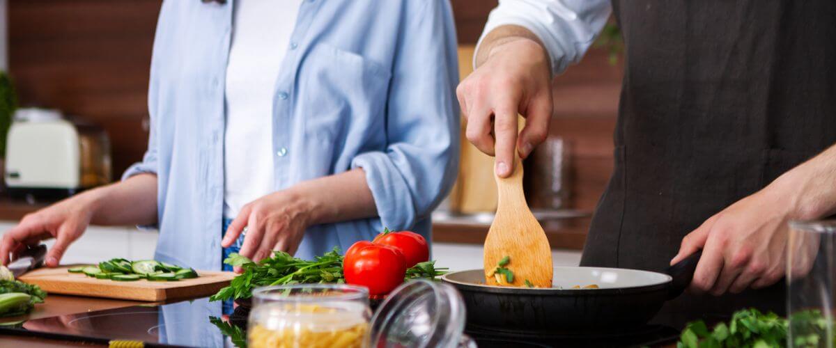 Couple cook dinner together learning how to connect in early marriage
