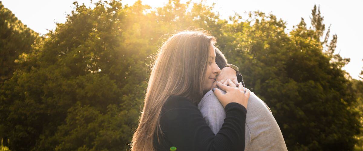 Couple embrace in the park as they emotional support each other in marriage