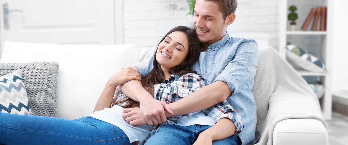 Couple sit on sofa after a stressful day
